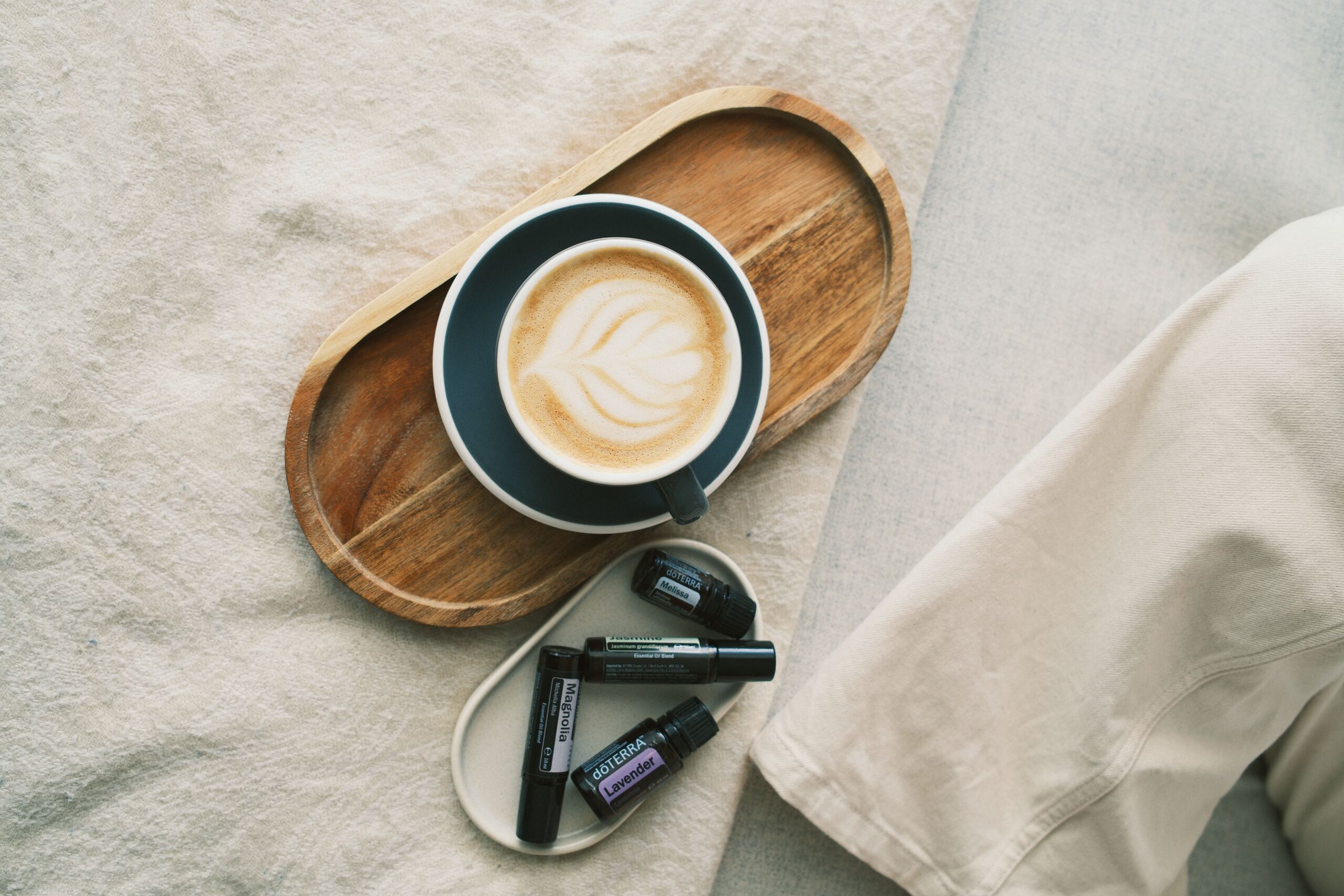 Coffee and essential oil rollers on a wooden tray