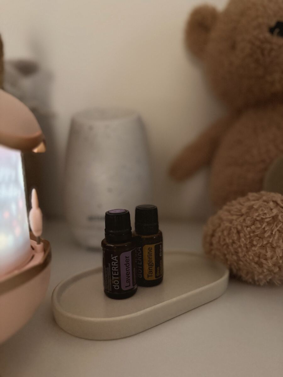 A diffuser with Lavender and Tangerine on a nursery shelf